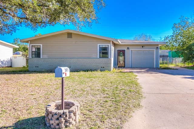 ranch-style house with a garage and a front lawn