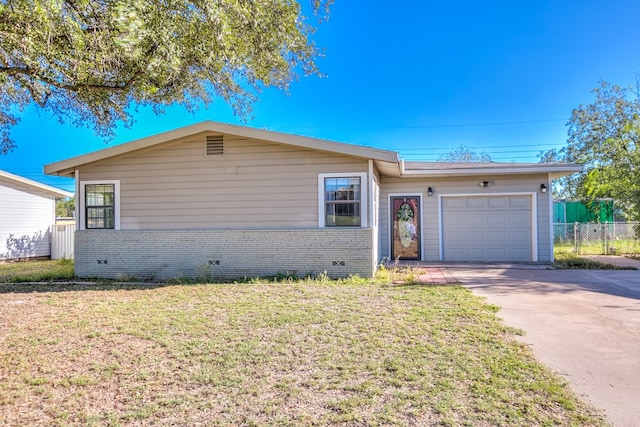 single story home featuring a garage and a front lawn