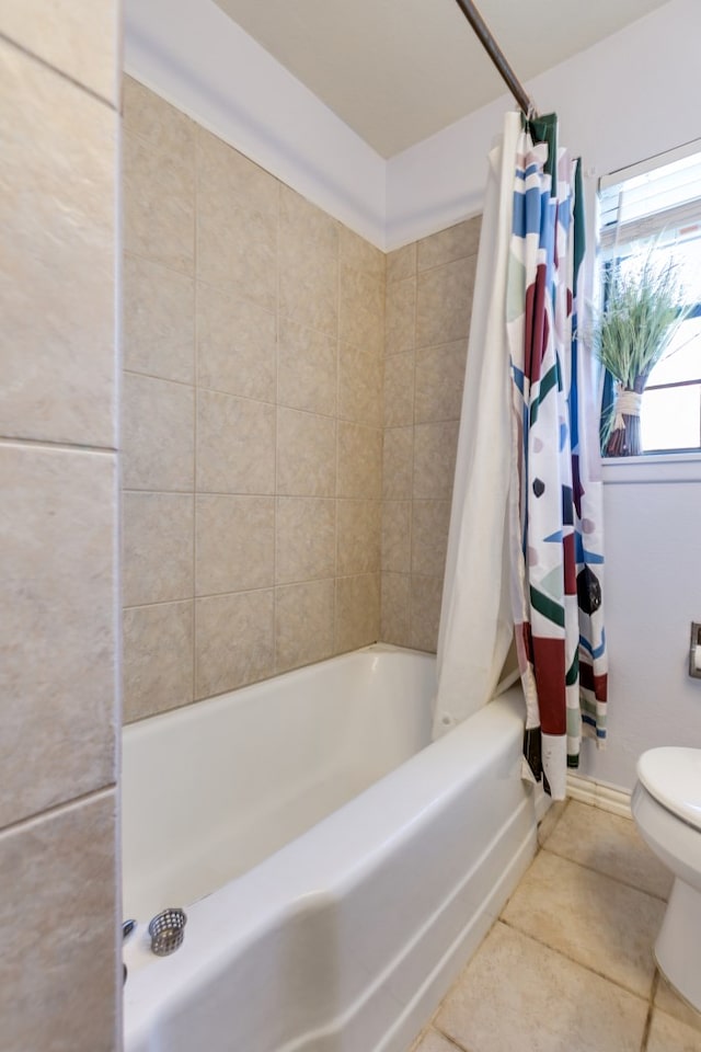 bathroom with tile patterned flooring, shower / tub combo, and toilet