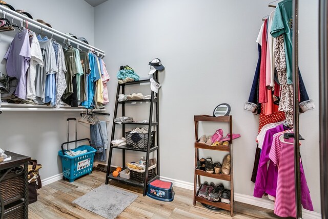 walk in closet featuring light hardwood / wood-style flooring