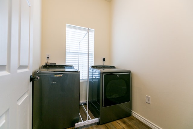 laundry area with dark hardwood / wood-style flooring and washing machine and dryer