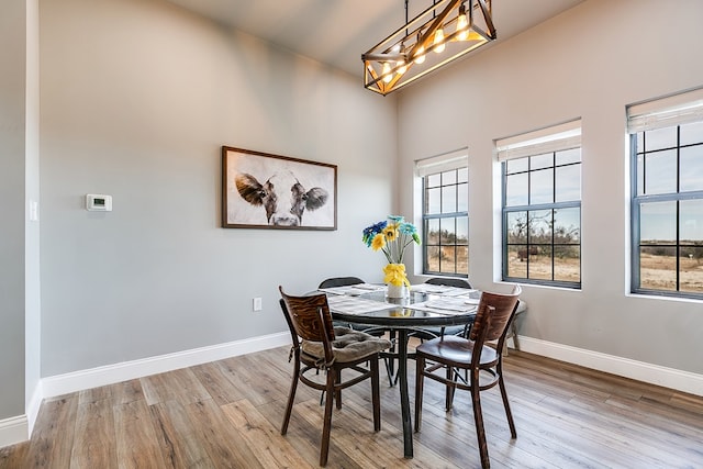 dining space with a chandelier and light wood-type flooring