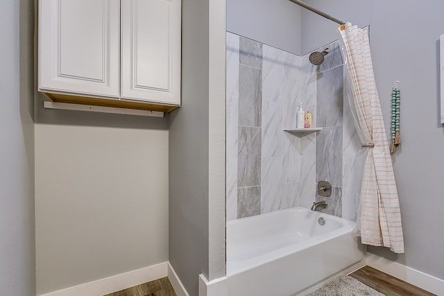 bathroom featuring shower / tub combo with curtain and hardwood / wood-style floors