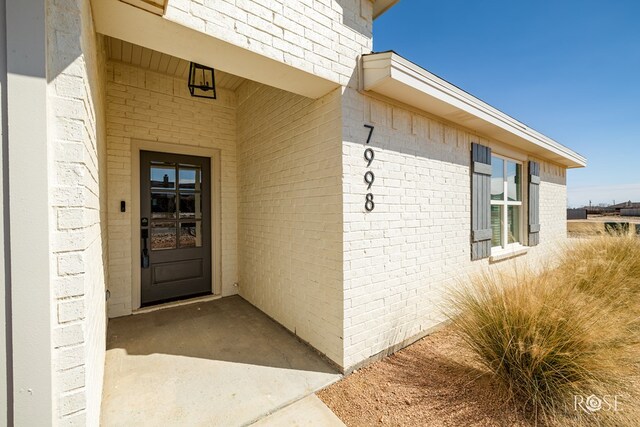 property entrance with brick siding