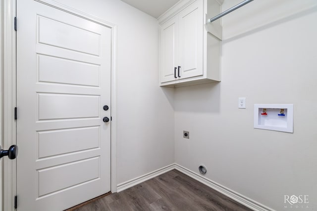 washroom featuring cabinet space, baseboards, dark wood finished floors, hookup for a washing machine, and hookup for an electric dryer