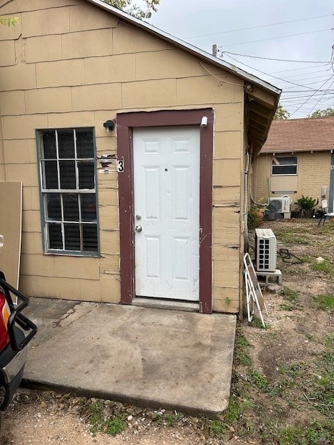 doorway to property featuring ac unit