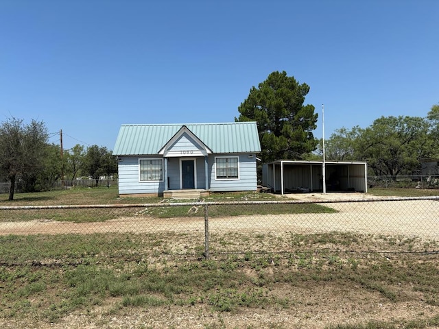 view of front of property with a front lawn and a carport