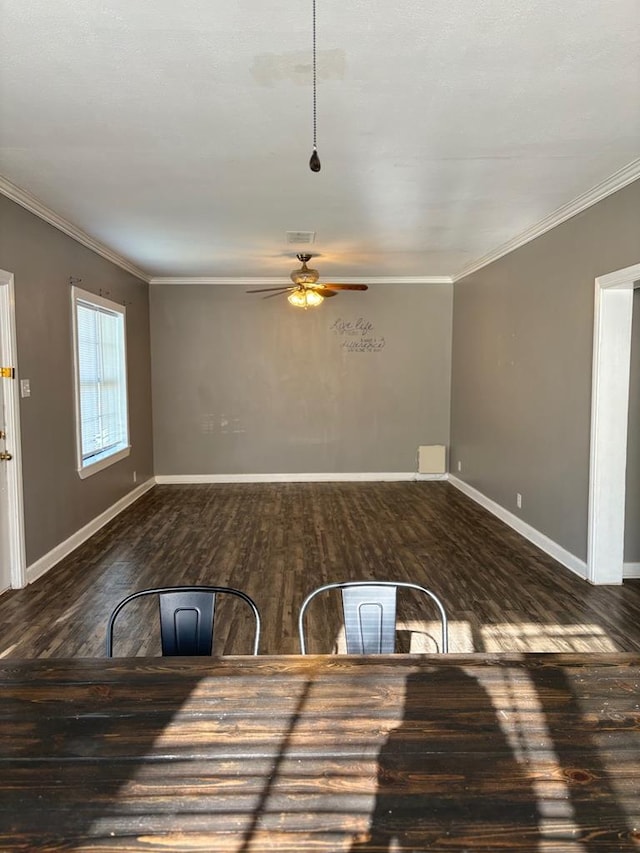 unfurnished living room featuring ornamental molding, ceiling fan, and dark hardwood / wood-style flooring