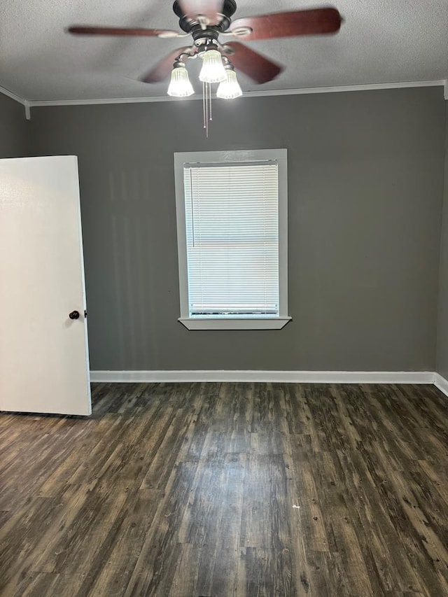 unfurnished room featuring crown molding, ceiling fan, dark hardwood / wood-style floors, and a textured ceiling