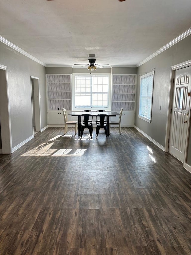 dining space with dark wood-type flooring and crown molding