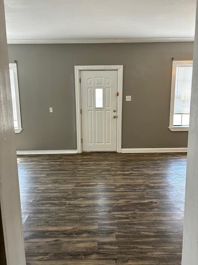 entryway with ornamental molding and dark hardwood / wood-style flooring