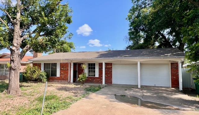 721 Spaulding St, San Angelo, TX 76903 - ranch-style house featuring a garage, driveway, and brick siding