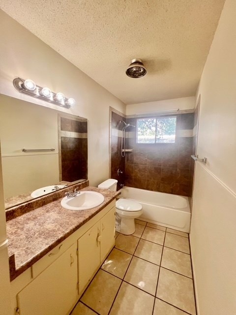 721 Spaulding St, San Angelo, TX 76903 - bathroom featuring vanity, tile patterned flooring, a textured ceiling, and shower / bath combination