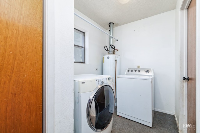 laundry area with washing machine and dryer, water heater, and a textured ceiling