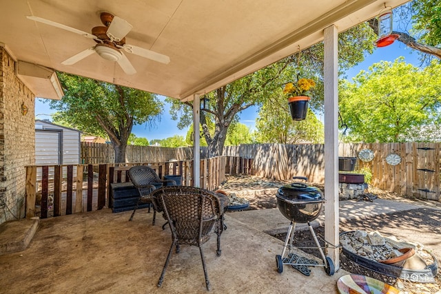 view of patio featuring ceiling fan and a storage unit