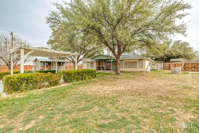 view of yard with fence and a pergola