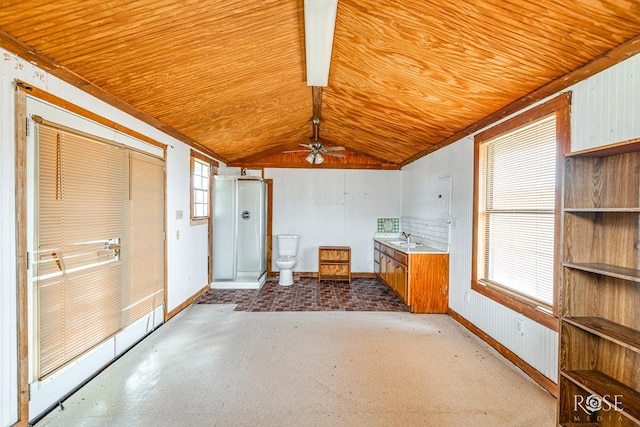 interior space featuring wooden ceiling, baseboards, vaulted ceiling, and a sink