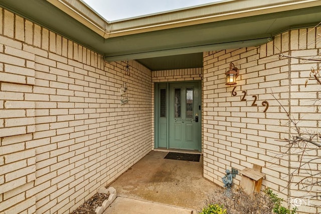 entrance to property with brick siding