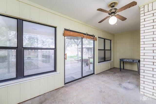 interior space with a ceiling fan and concrete flooring