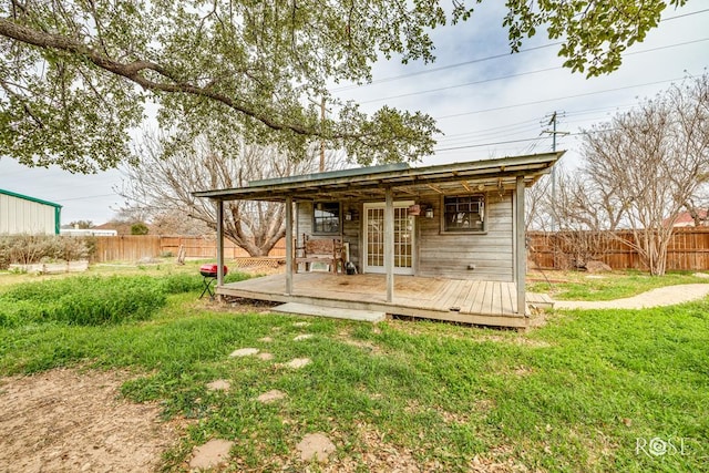 view of outbuilding with a fenced backyard and french doors