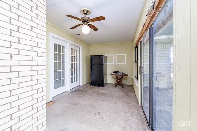 unfurnished sunroom with visible vents, a ceiling fan, and french doors