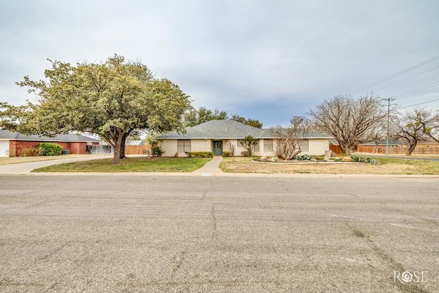 ranch-style house with fence