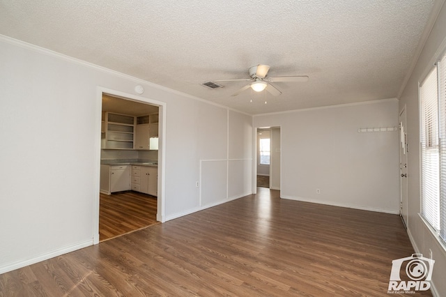 empty room with dark hardwood / wood-style flooring, ceiling fan, crown molding, and a textured ceiling