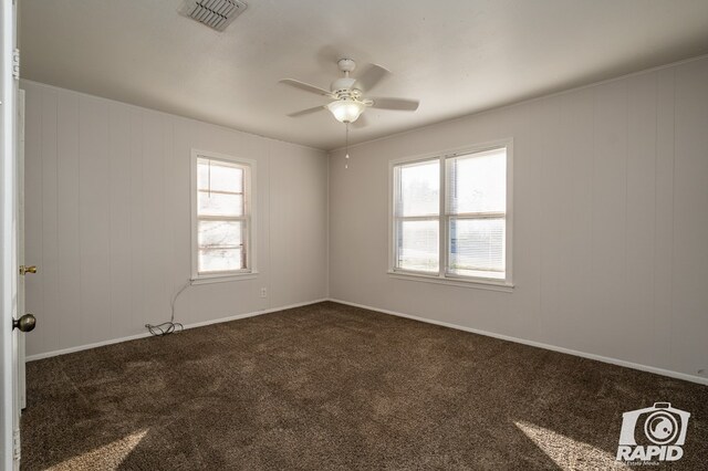 carpeted spare room with ceiling fan