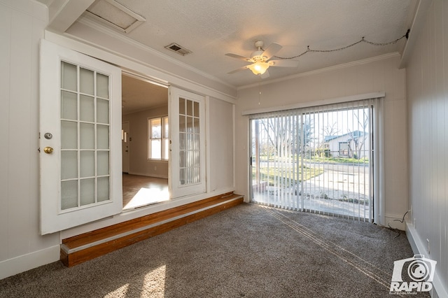 unfurnished room featuring ornamental molding, plenty of natural light, carpet, and a textured ceiling