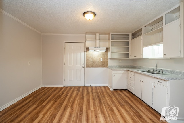 kitchen featuring white cabinetry, sink, a textured ceiling, and light wood-type flooring