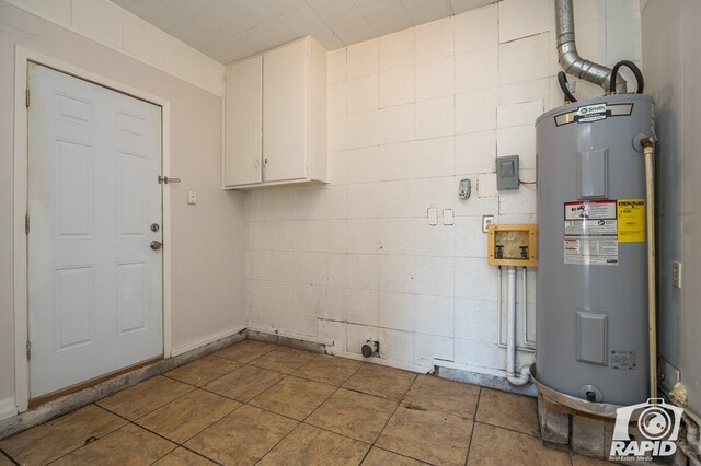 clothes washing area featuring electric dryer hookup, cabinets, hookup for a washing machine, and water heater