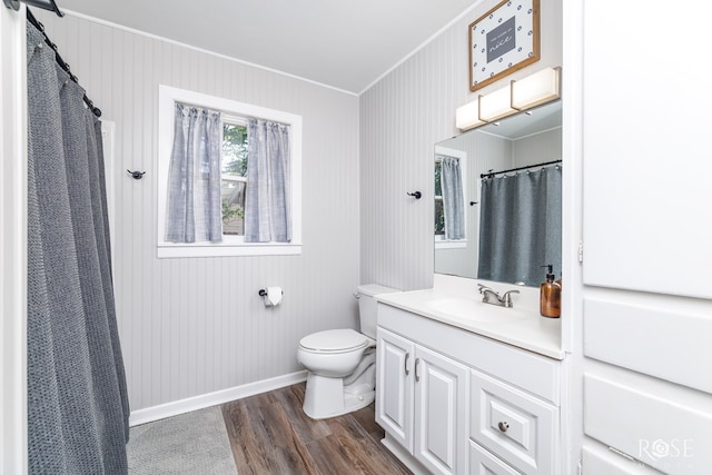 117 Windham St, San Angelo, TX 76903 - full bathroom with crown molding, toilet, vanity, wood finished floors, and baseboards