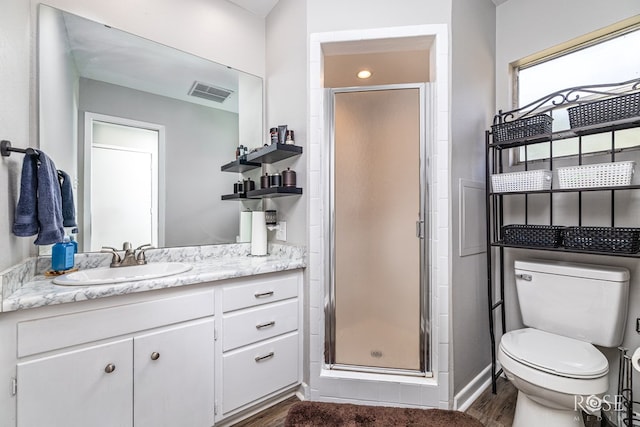 117 Windham St, San Angelo, TX 76903 - bathroom with vanity, toilet, a shower stall, and wood finished floors
