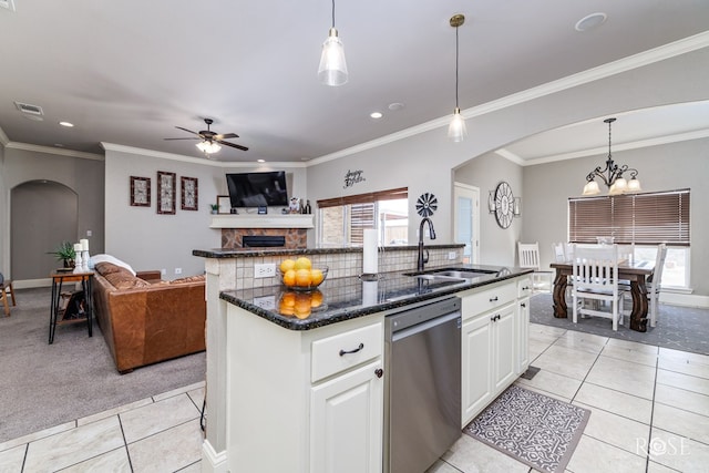 kitchen with dishwasher, light tile patterned flooring, white cabinets, and an island with sink