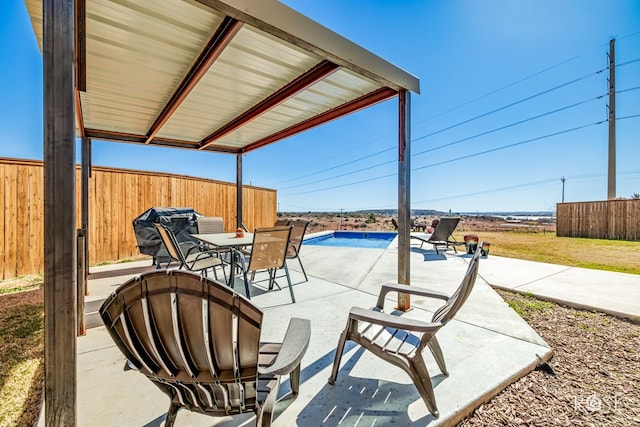 view of patio with a fenced in pool