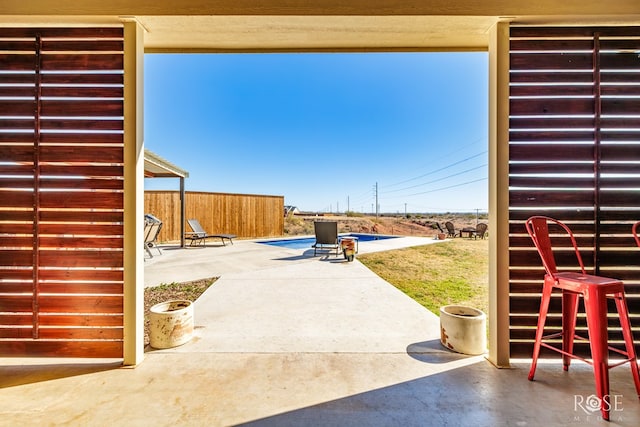 view of patio with a fenced in pool