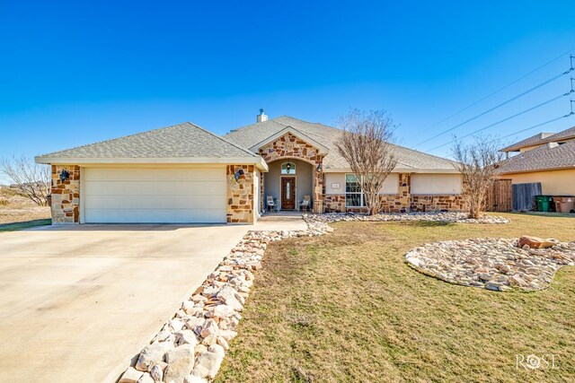 ranch-style home featuring a garage and a front lawn