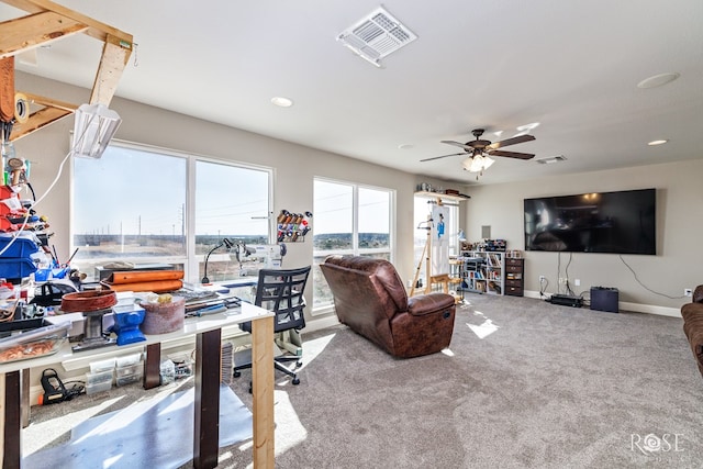 living room featuring plenty of natural light, ceiling fan, and carpet