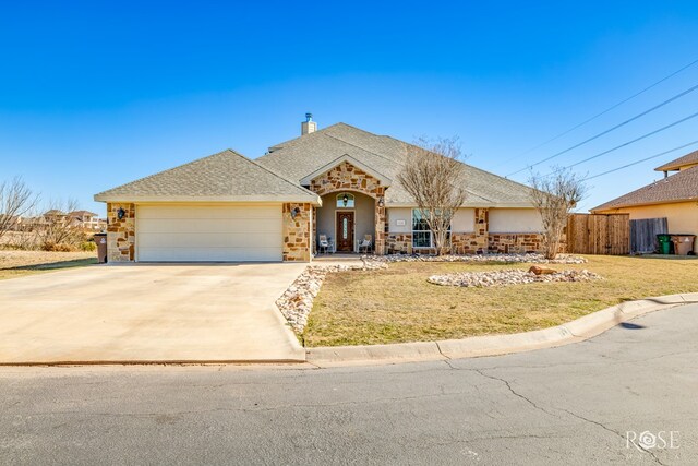 single story home featuring a garage and a front lawn