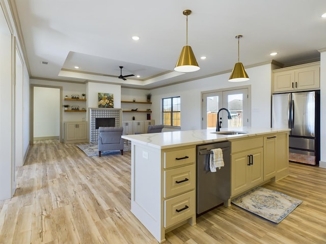 3608 Clearview Dr, San Angelo, TX 76904 - kitchen featuring appliances with stainless steel finishes, crown molding, light wood finished floors, a tray ceiling, and a ceiling fan