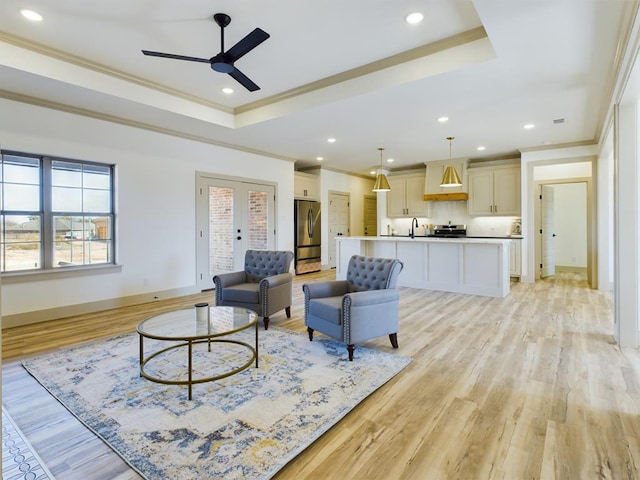 3608 Clearview Dr, San Angelo, TX 76904 - living room featuring a raised ceiling, ornamental molding, ceiling fan, light wood-style floors, and recessed lighting