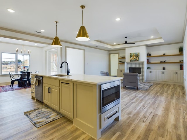 3608 Clearview Dr, San Angelo, TX 76904 - kitchen with appliances with stainless steel finishes, ornamental molding, a chandelier, ceiling fan, and light wood-style flooring