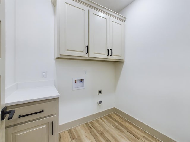 3608 Clearview Dr, San Angelo, TX 76904 - washroom featuring washer hookup, cabinet space, light wood finished floors, and electric dryer hookup
