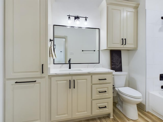 3608 Clearview Dr, San Angelo, TX 76904 - bathroom featuring vanity, wood finished floors, and washtub / shower combination