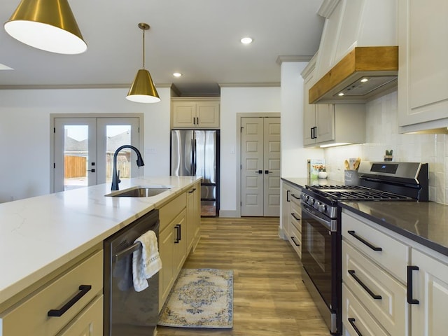 3608 Clearview Dr, San Angelo, TX 76904 - kitchen with appliances with stainless steel finishes, premium range hood, crown molding, backsplash, and pendant lighting