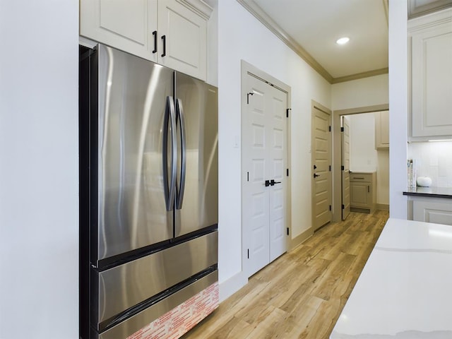 3608 Clearview Dr, San Angelo, TX 76904 - kitchen with freestanding refrigerator, ornamental molding, light wood-style floors, white cabinetry, and recessed lighting