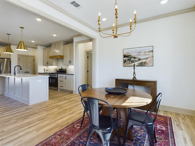 3608 Clearview Dr, San Angelo, TX 76904 - dining room with a chandelier, light wood finished floors, recessed lighting, and ornamental molding