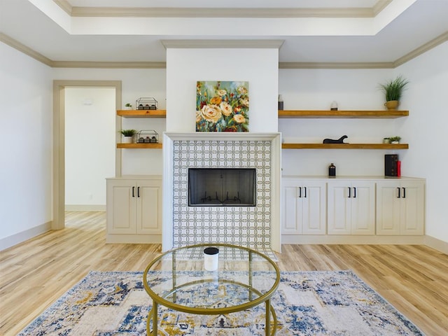 3608 Clearview Dr, San Angelo, TX 76904 - living area featuring a raised ceiling, light wood-type flooring, ornamental molding, and a fireplace