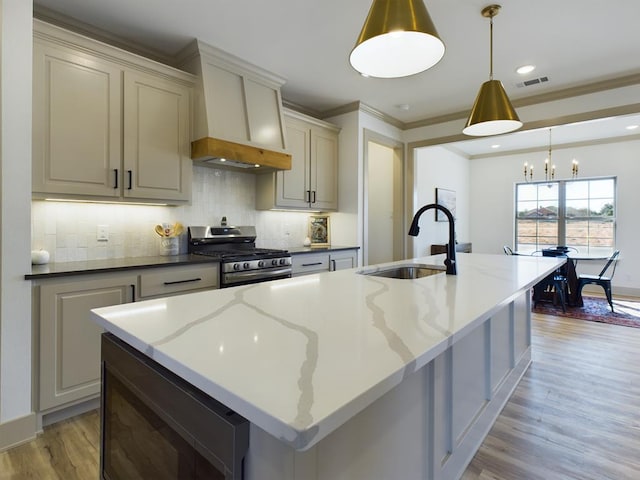 3608 Clearview Dr, San Angelo, TX 76904 - kitchen with stainless steel range with gas stovetop, custom range hood, light wood-type flooring, backsplash, and ornamental molding