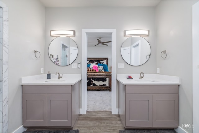 4992 Silver Creek Pass, San Angelo, TX 76904 - bathroom featuring ceiling fan, wood finished floors, and two vanities